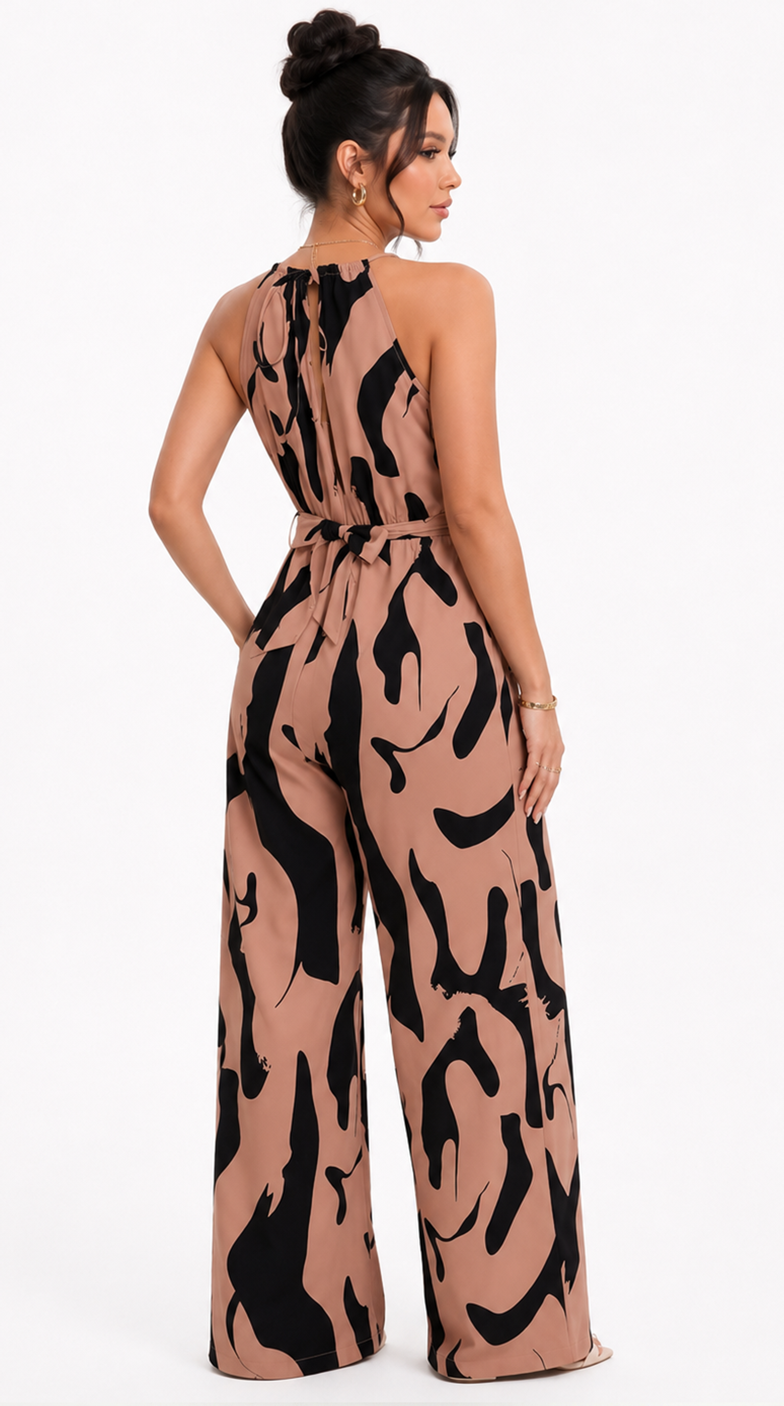 Woman wearing a tan and black patterned jumpsuit on a white background, from Meleche Fashion USA or Meléche (short as (Mé))