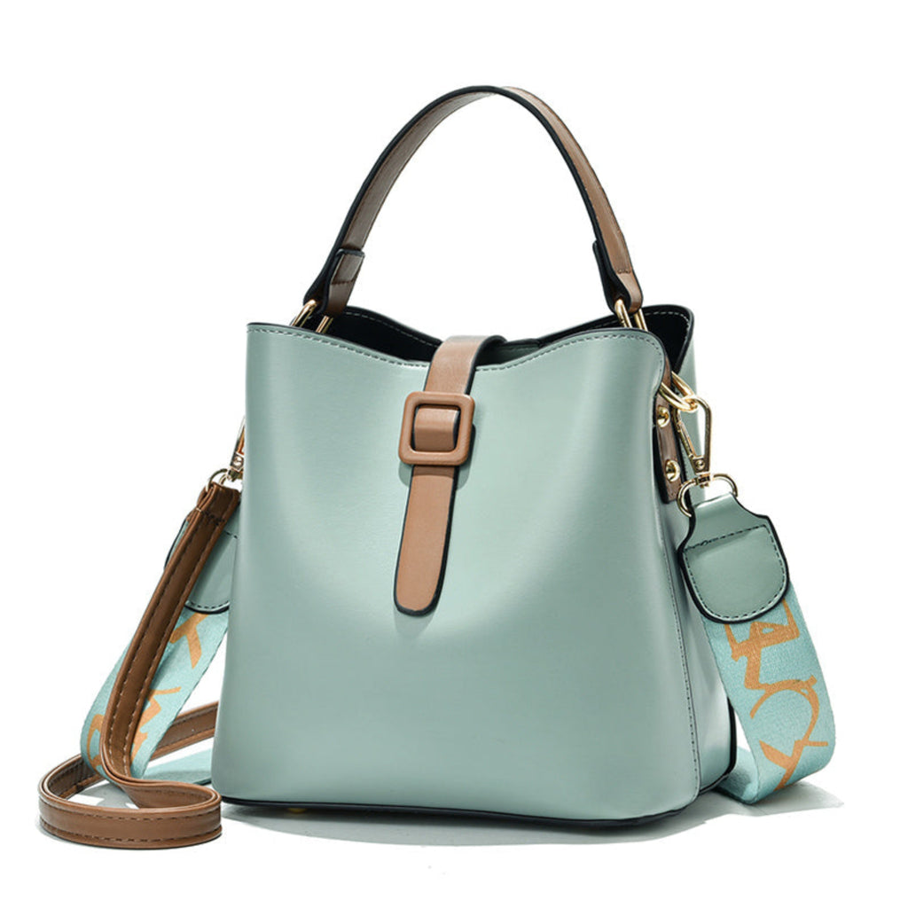 Light blue handbag with brown straps on a white background