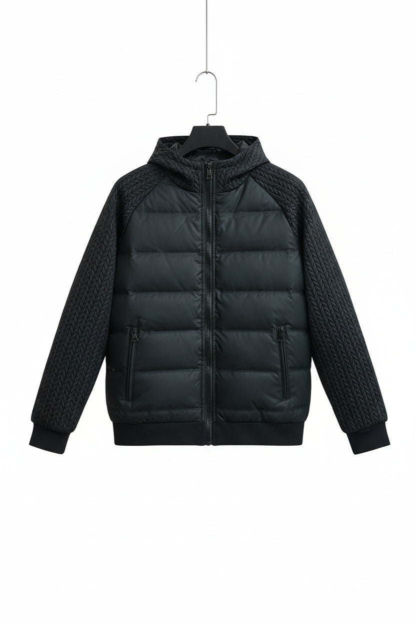 Black puffer jacket with braided sleeves on a hanger against an orange background