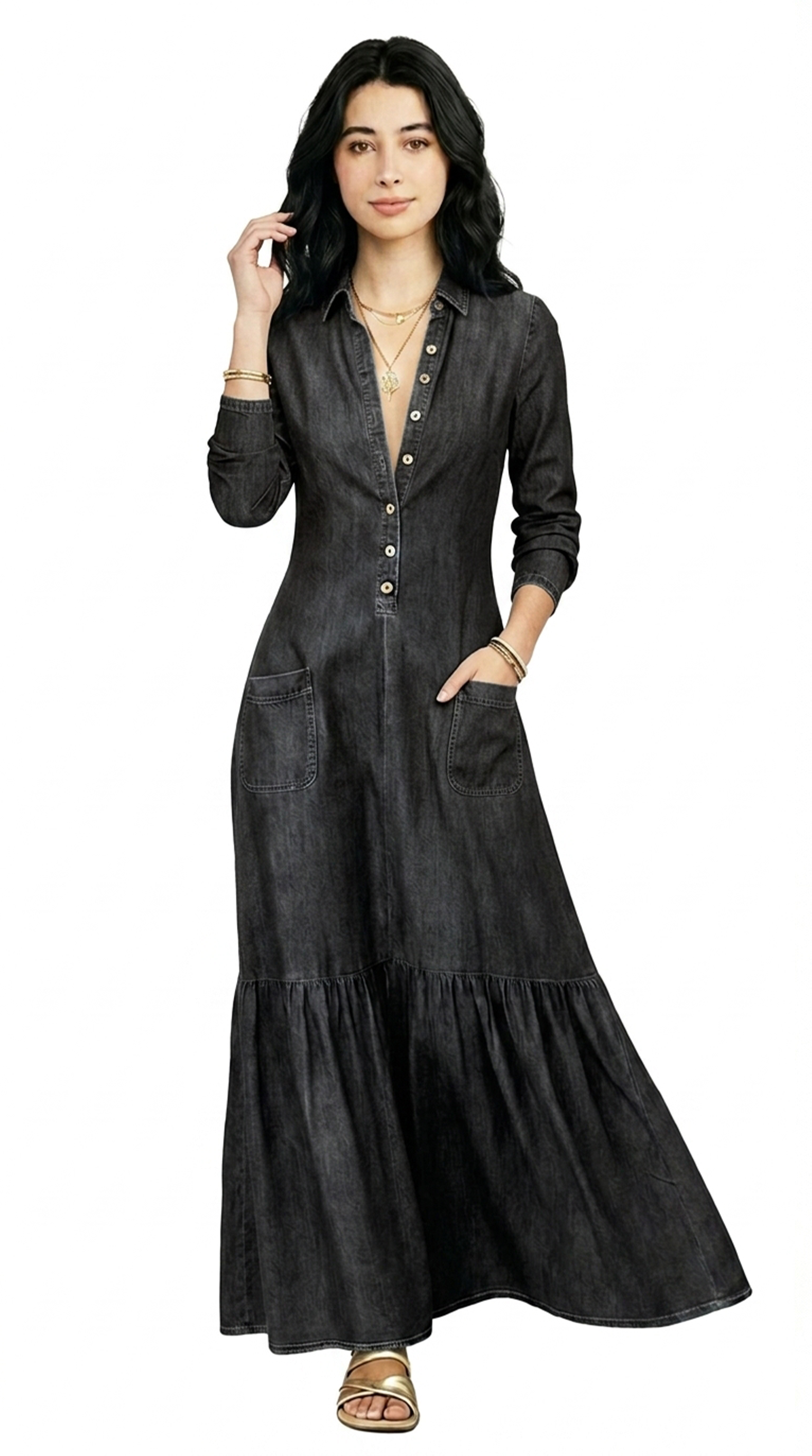 Woman wearing a long black dress with layered skirt on a white background