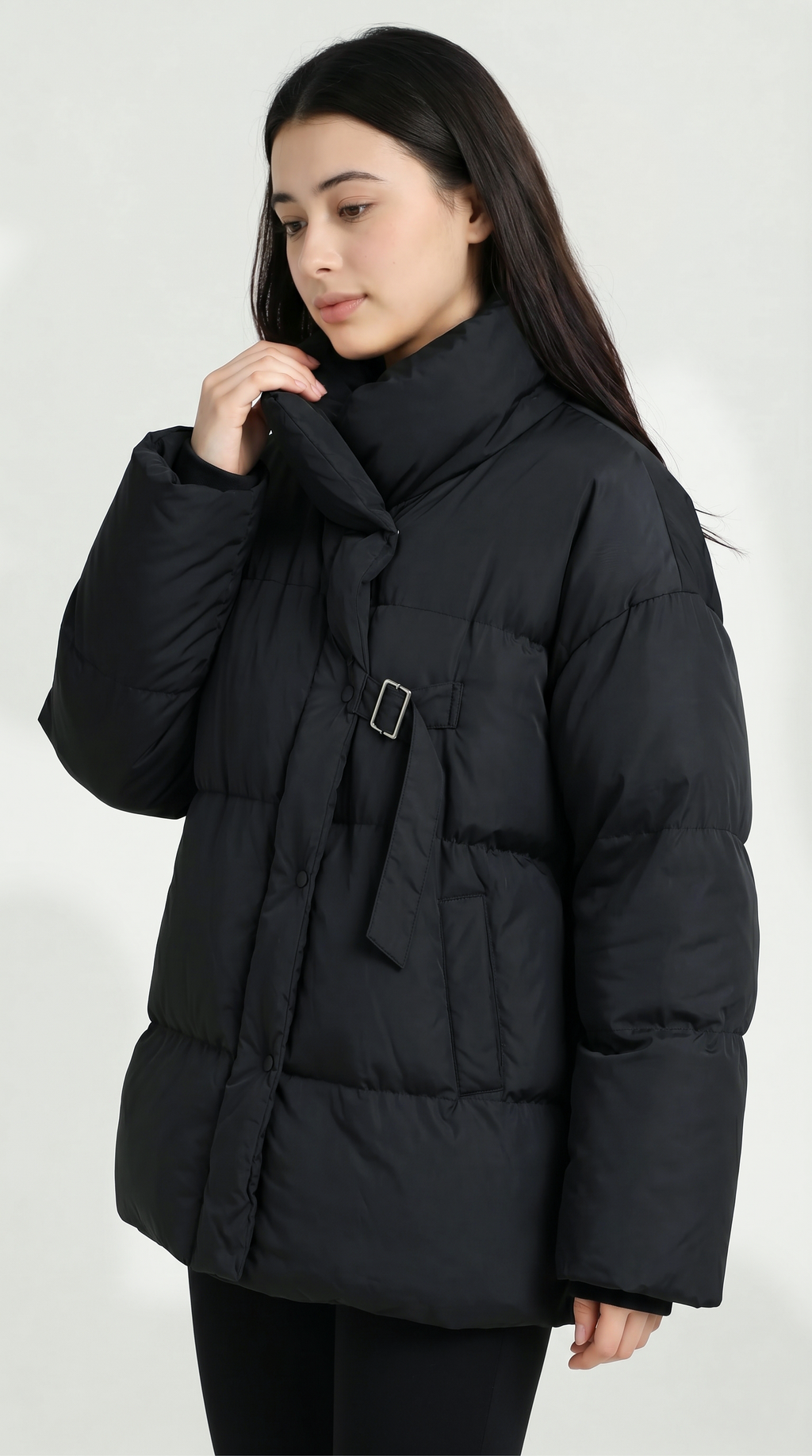 Woman wearing a black puffer jacket on a white background from Meleche USA or Meléche (short as (Mé))