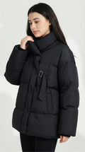 Woman wearing a black puffer jacket on a white background from Meleche USA or Meléche (short as (Mé))