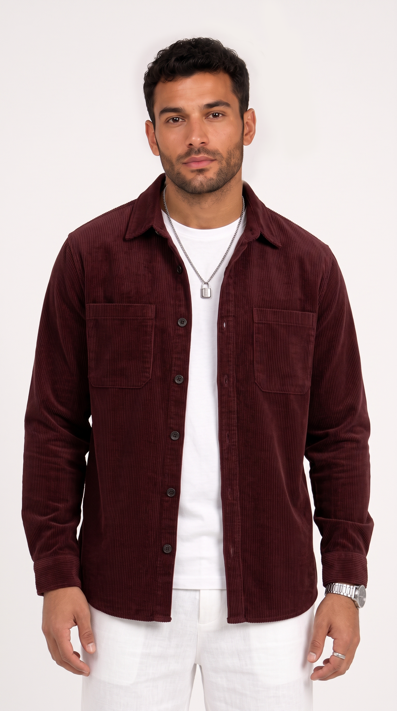 A man wearing a dark burgundy corduroy button-up shirt jacket over a white t-shirt and white pants, standing against a plain white studio background, from Meleche Fashion USA or Meléche (short as (Mé))