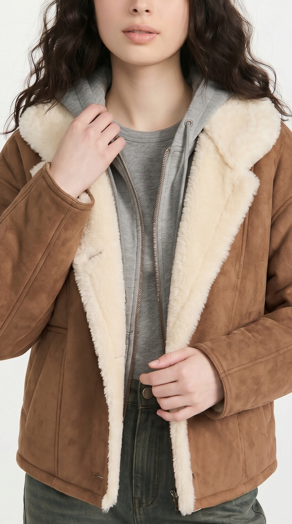 Person wearing a brown shearling jacket with white fur lining on a white background from Meleche USA or Meléche (short as (Mé))