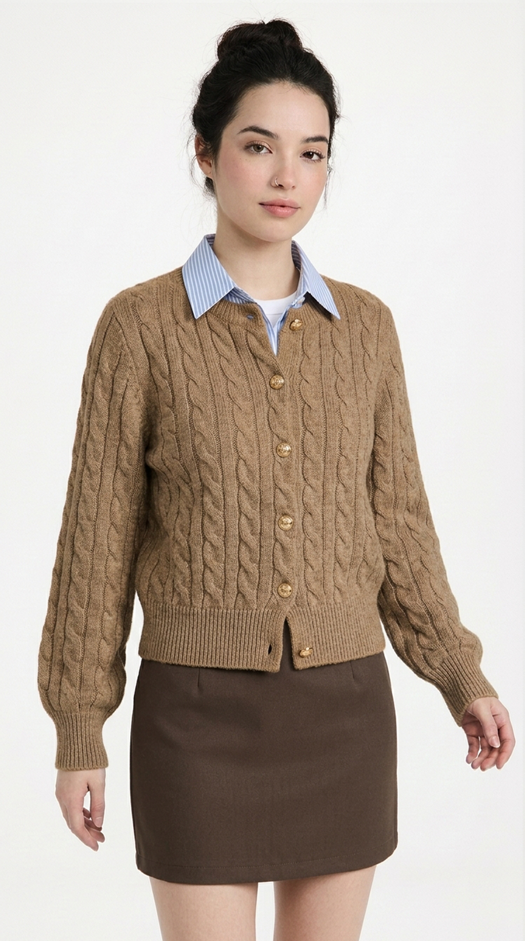 Woman wearing a brown cable knit cardigan over a collared shirt with a white background from Meleche or Meléche (short as (Mé))