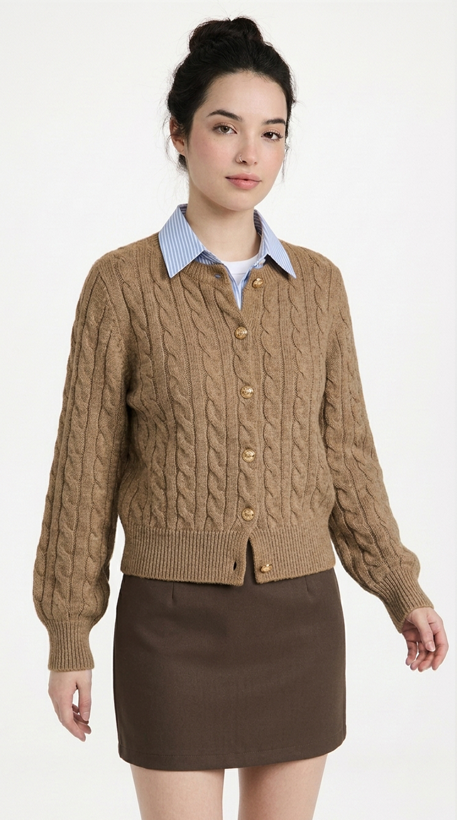 Woman wearing a brown cable knit cardigan over a collared shirt with a white background from Meleche or Meléche (short as (Mé))