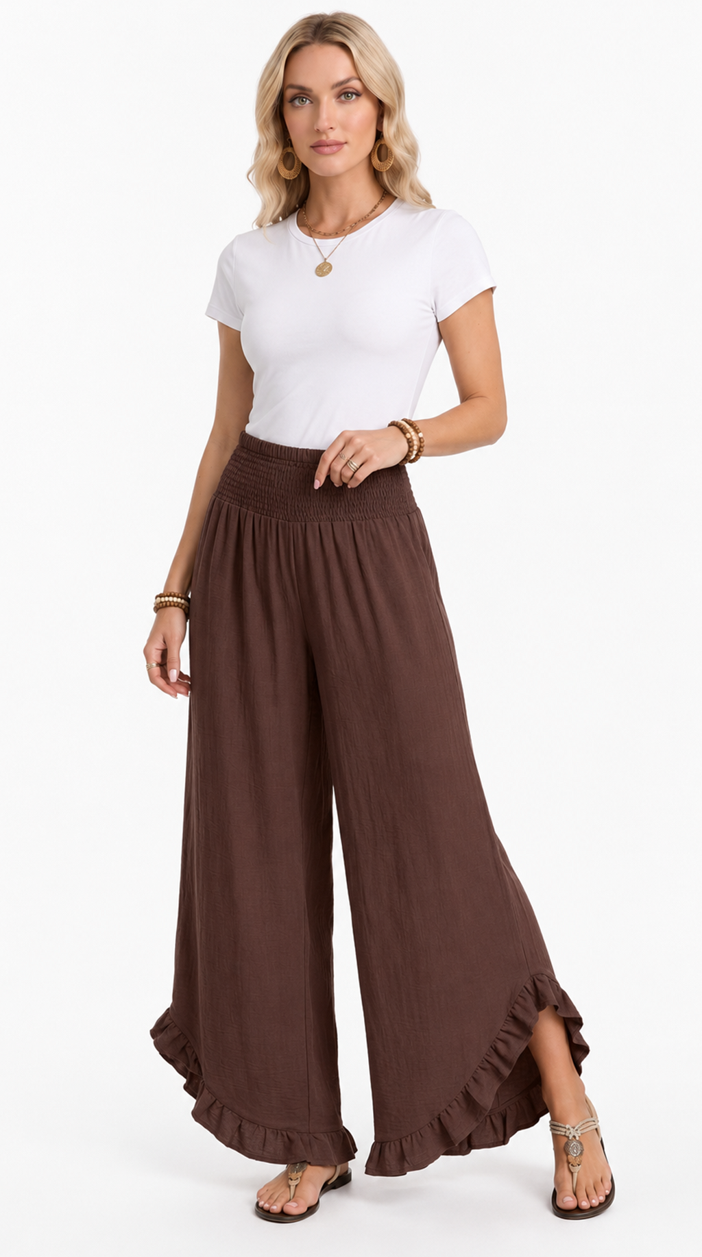 Woman wearing a white top and brown wide-leg pants on a white background