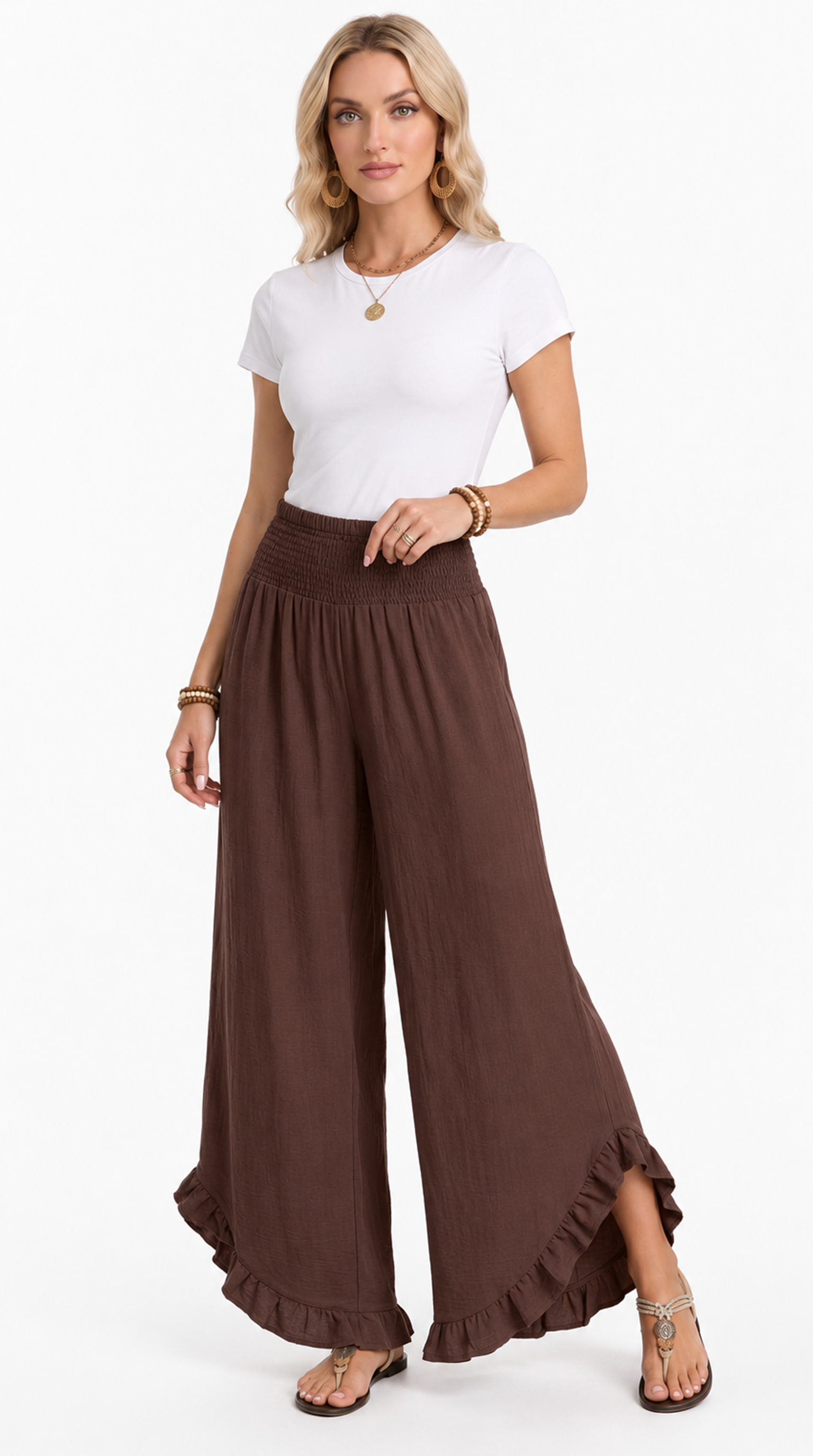 Woman wearing a white top and brown wide-leg pants on a white background