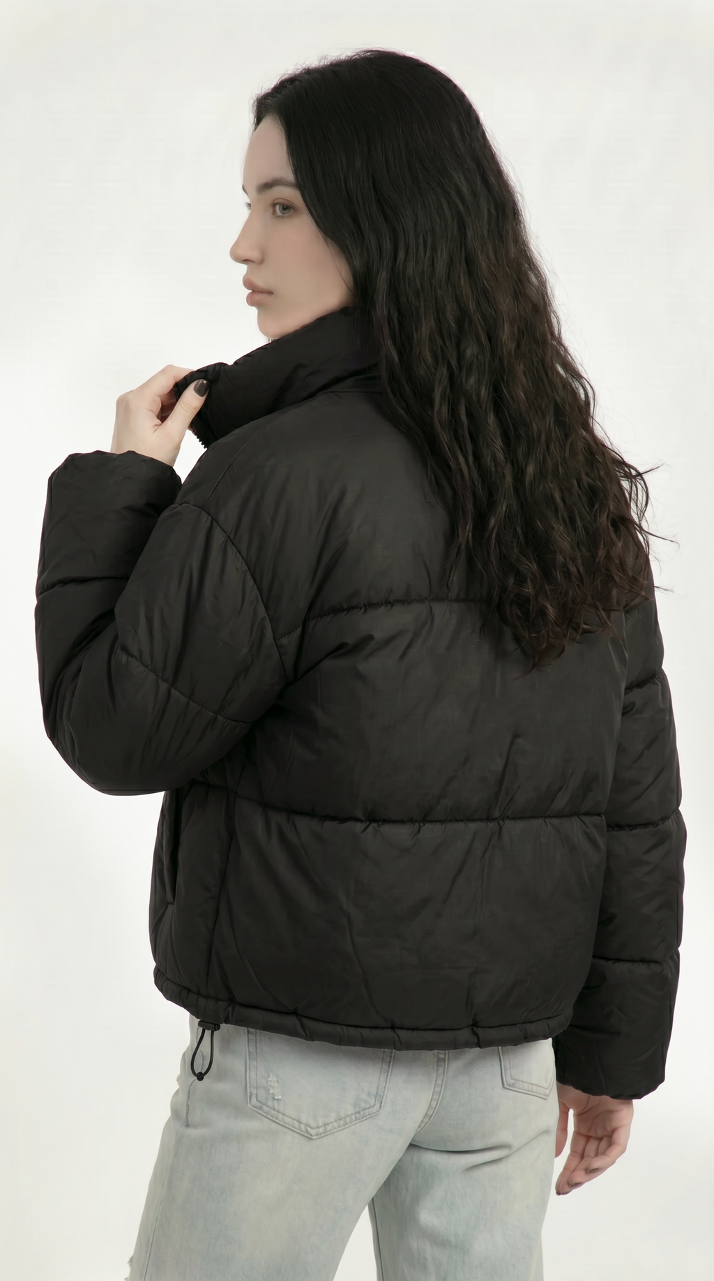 Person wearing a black puffer jacket on a white background from Meleche or Meléche USA (short as (Mé))