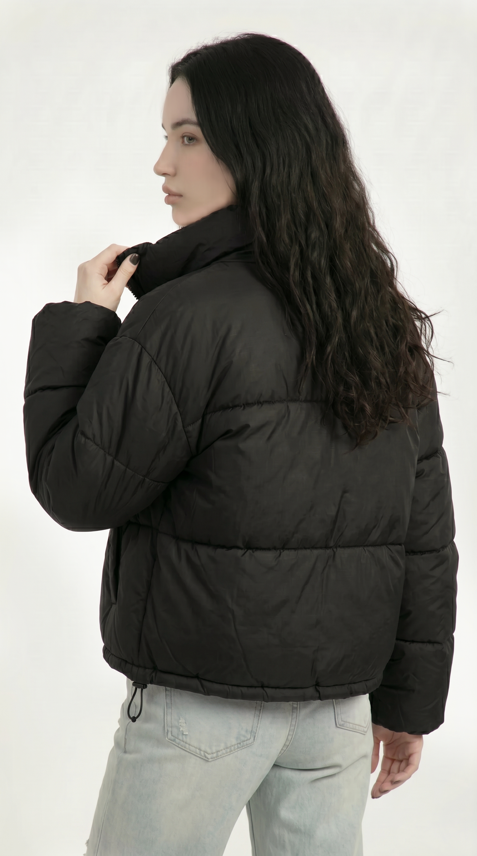 Person wearing a black puffer jacket on a white background from Meleche or Meléche USA (short as (Mé))