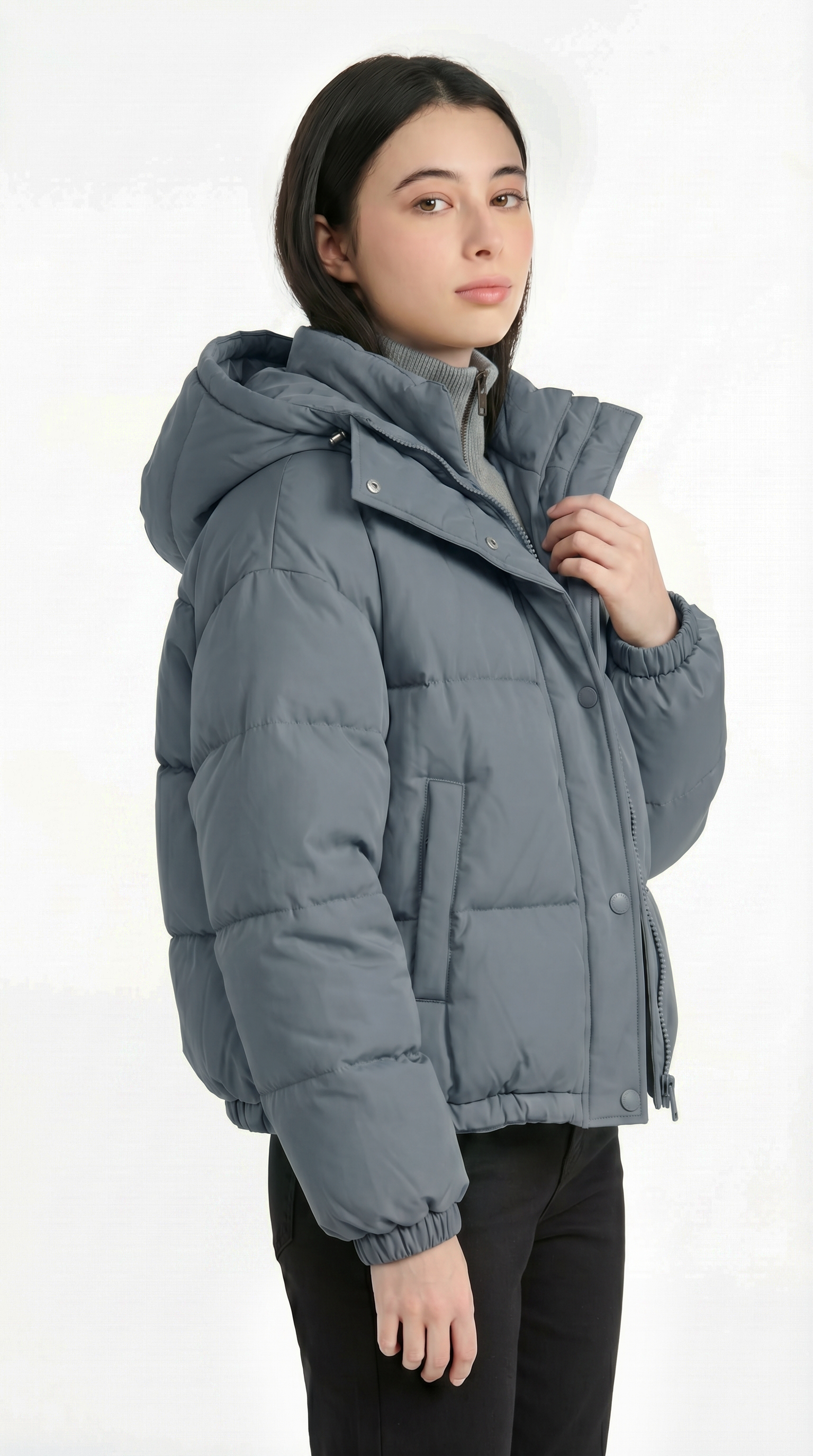 Person wearing a gray puffer jacket on a white background from Meleche USA or Meléche (short as (Mé))