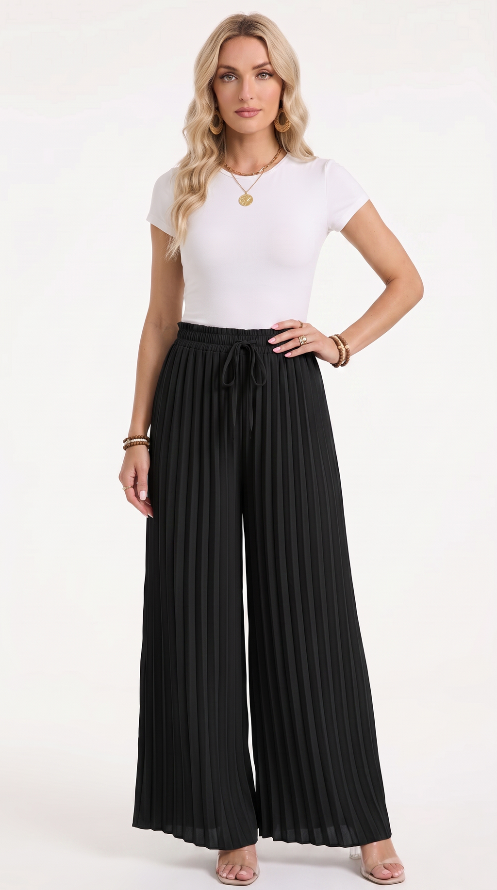 A woman modeling a white short-sleeve crewneck top and black pleated wide-leg drawstring pants against a plain white studio background, from Meleche Fashion USA or Meléche (short as (Mé))