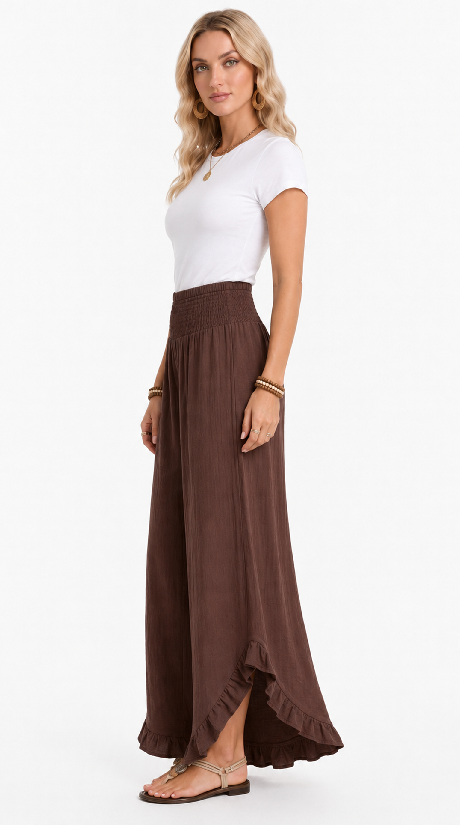 Woman wearing a white top and brown maxi skirt on a white background