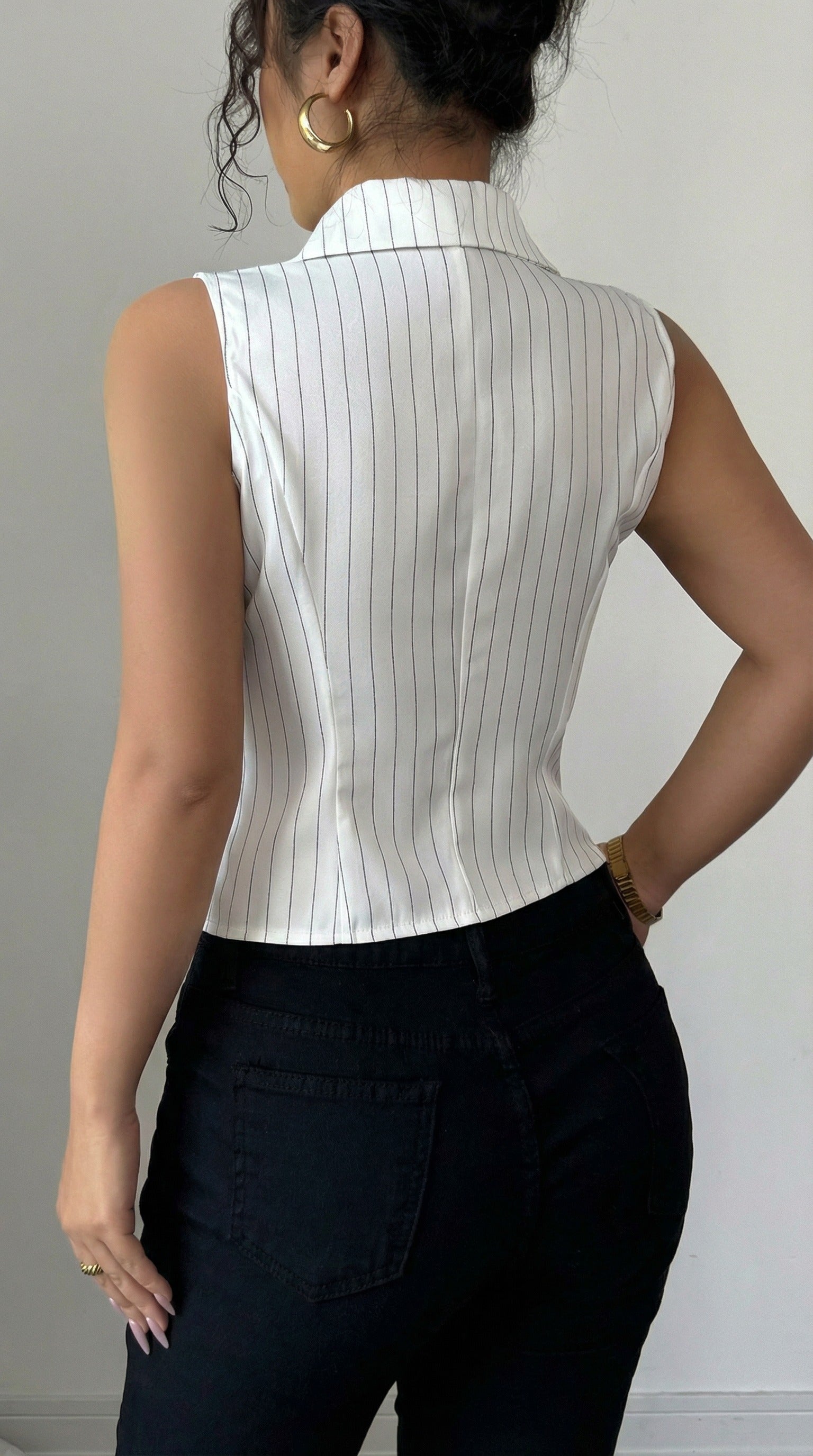 Person wearing a white sleeveless ribbed top against a gray background from Meleche or Meléche (short as (Mé))