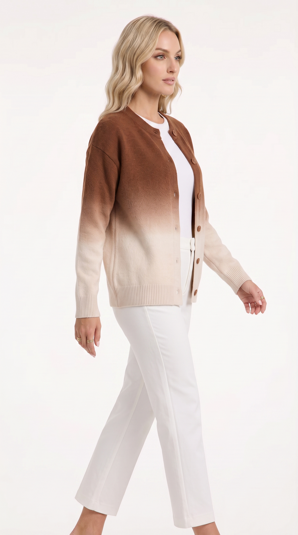 A woman modeling a brown and cream gradient cardigan over a white top and white pants, photographed against a clean white studio background, from Meleche Fashion USA or Meléche (short as (Mé))
