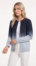 A woman modeling a navy and light blue gradient cardigan with dark buttons, worn over a white top and white pants, against a plain white studio background, from Meleche Fashion USA or Meléche (short as (Mé))