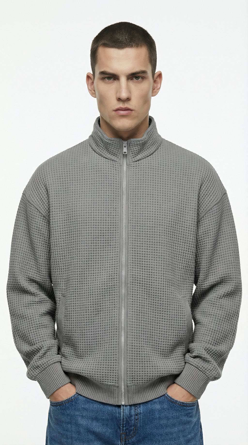 Man wearing a gray checkered zip-up sweatshirt from Meleche or Meléche (short as (Mé))