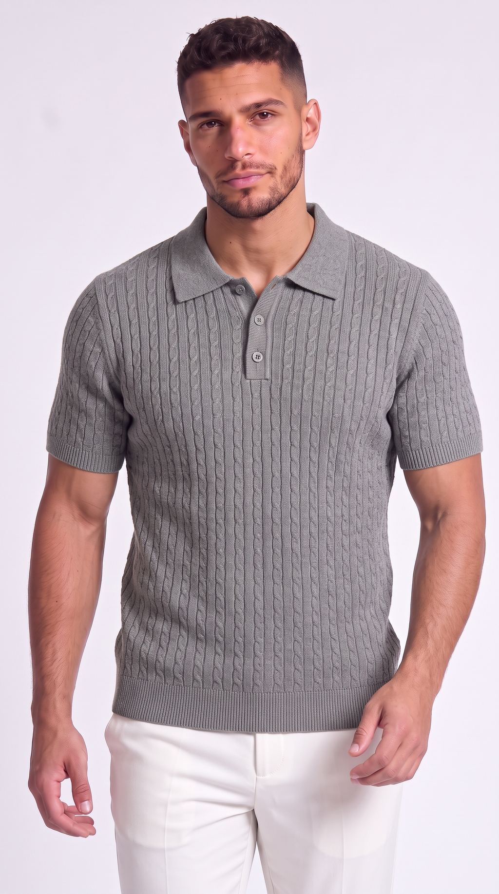 A man wearing a gray short-sleeve polo shirt with a cable-knit pattern and white pants, standing against a light gray studio background, from Meleche Fashion USA or Meléche (short as (Mé))