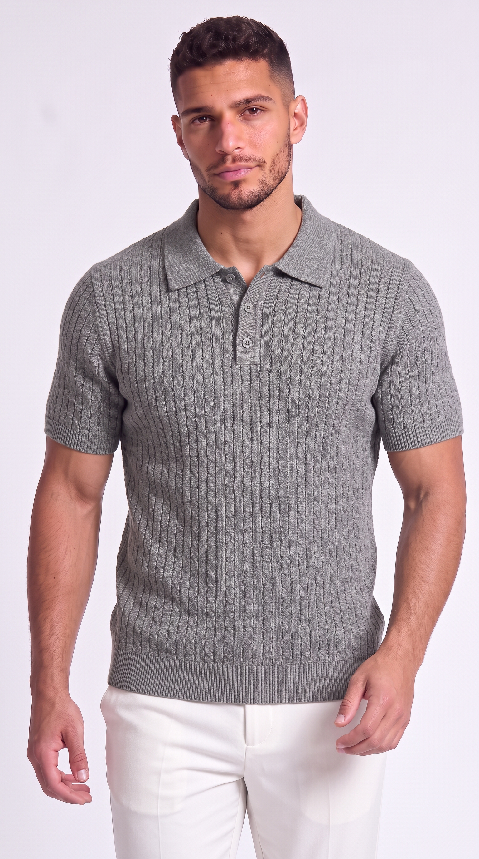 A man wearing a gray short-sleeve polo shirt with a cable-knit pattern and white pants, standing against a light gray studio background, from Meleche Fashion USA or Meléche (short as (Mé))