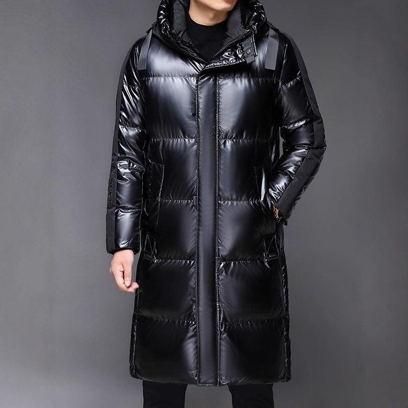 Black puffer coat worn by a person on a gray background