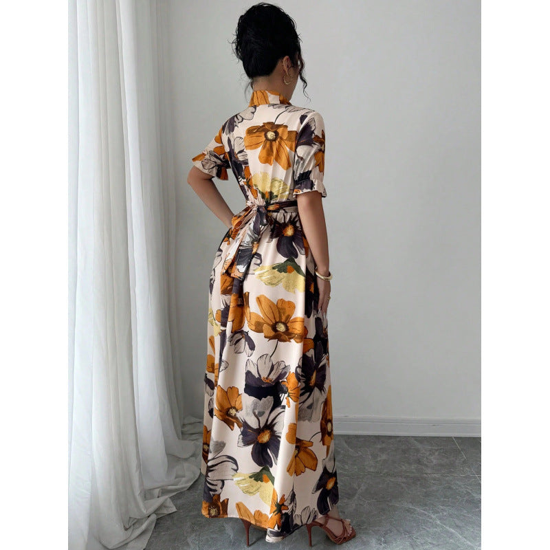 Woman wearing a floral dress standing in a room with white curtains.