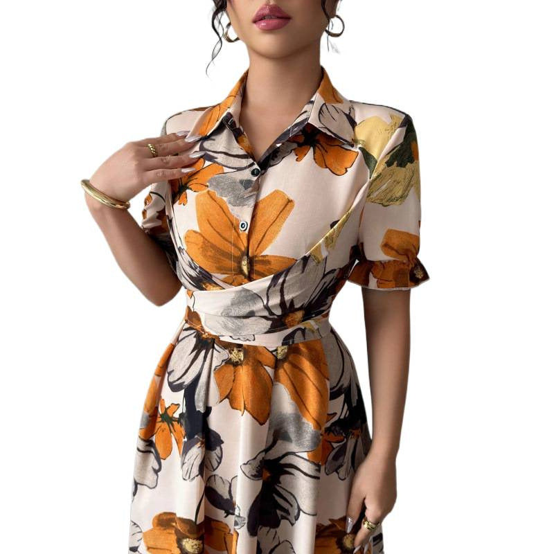 Woman wearing a floral dress with orange and black patterns on a white background