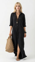 Woman wearing a black dress holding a woven bag against a neutral background