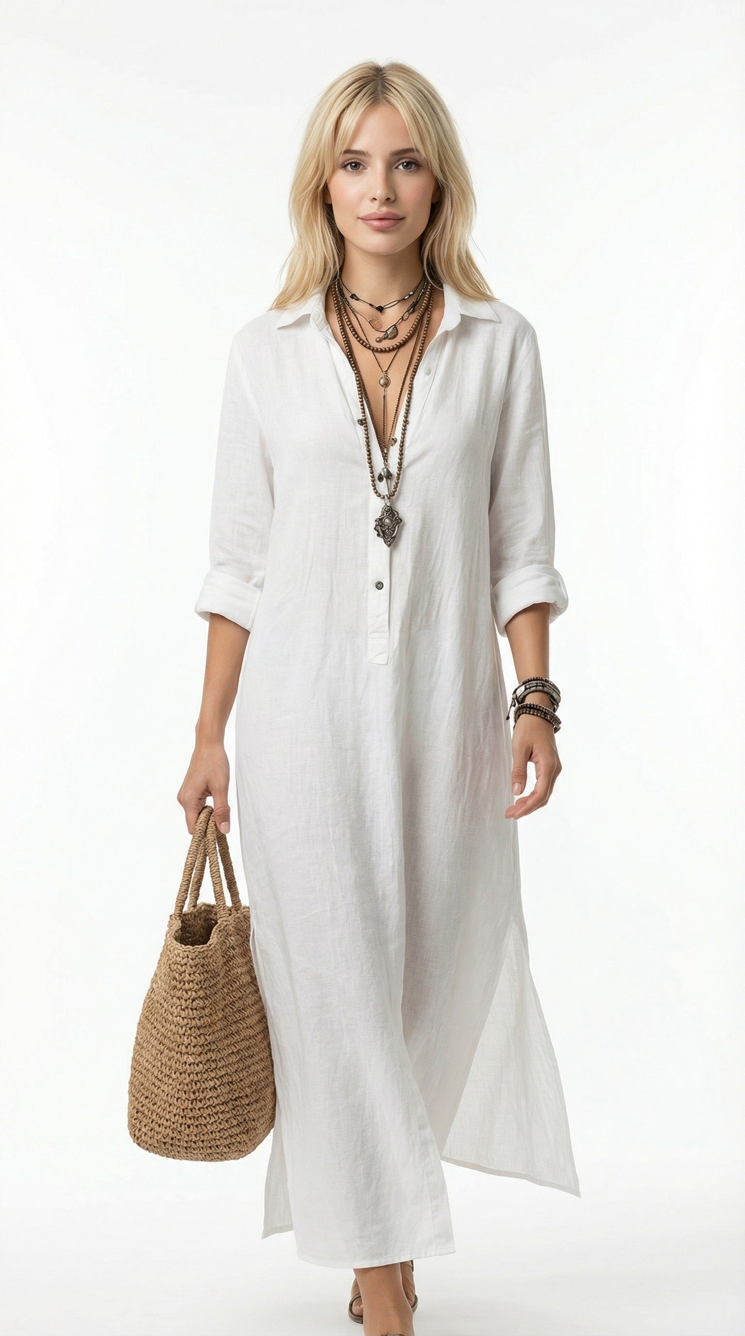 Woman wearing a long white dress holding a woven bag against a neutral background