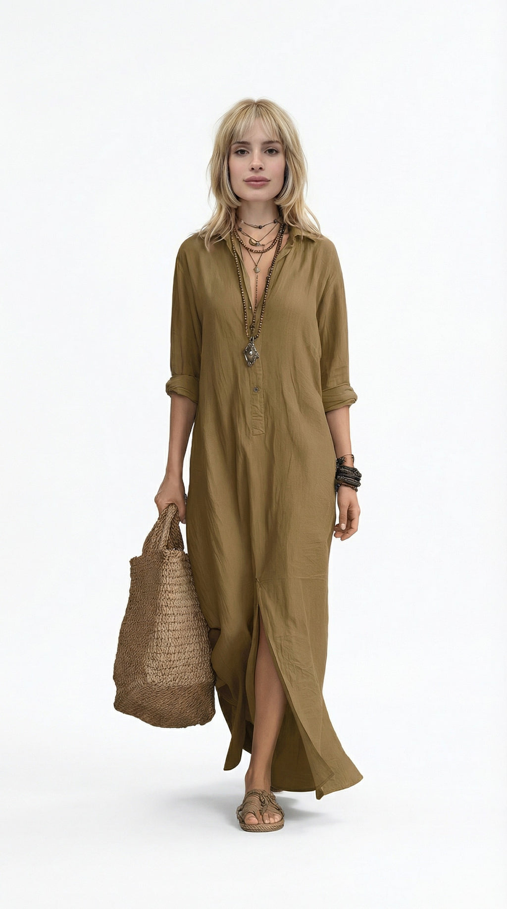 Woman wearing a long olive green dress holding a woven bag on a white background