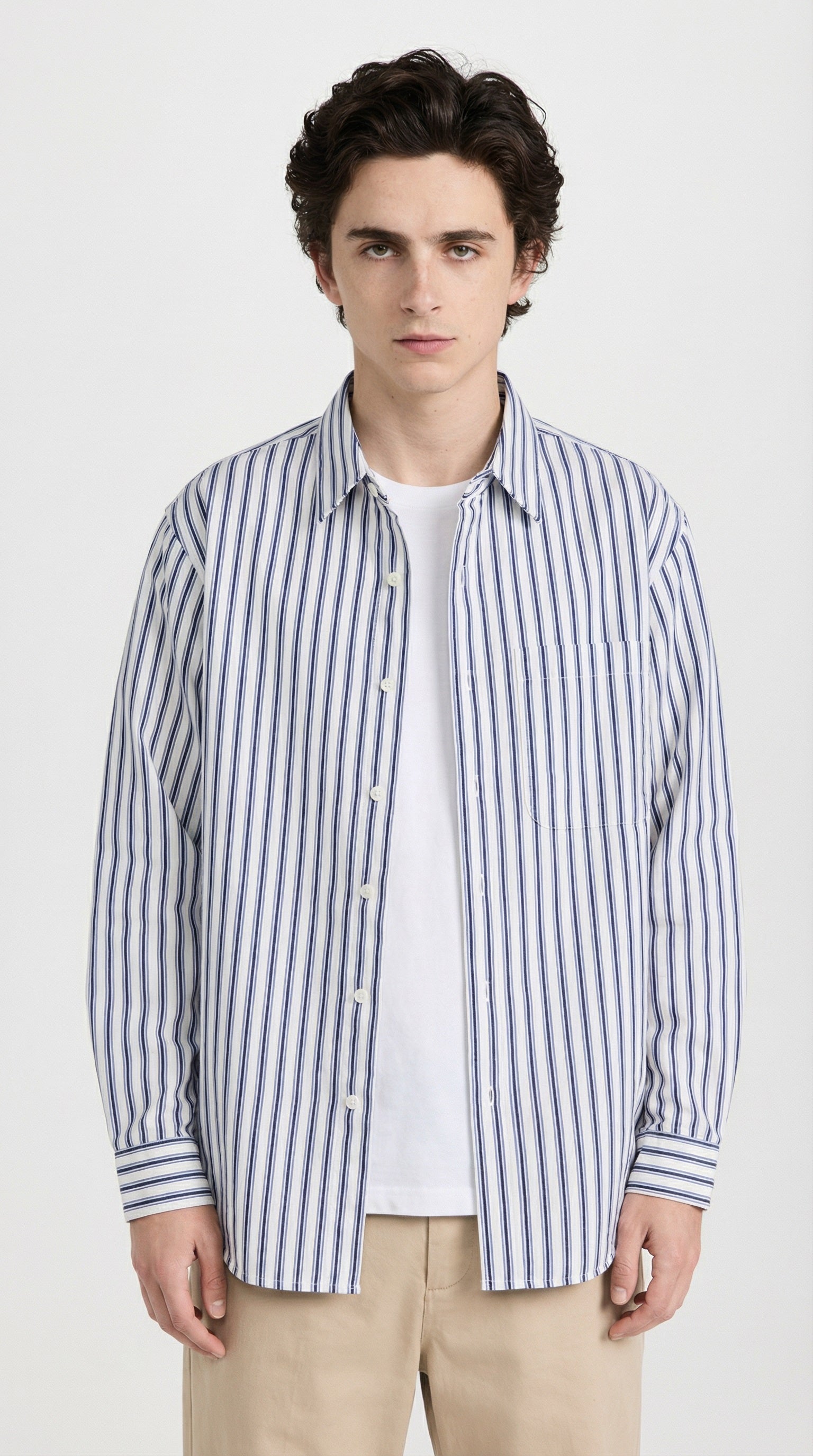 Person wearing a blue and white striped shirt on a light gray background
