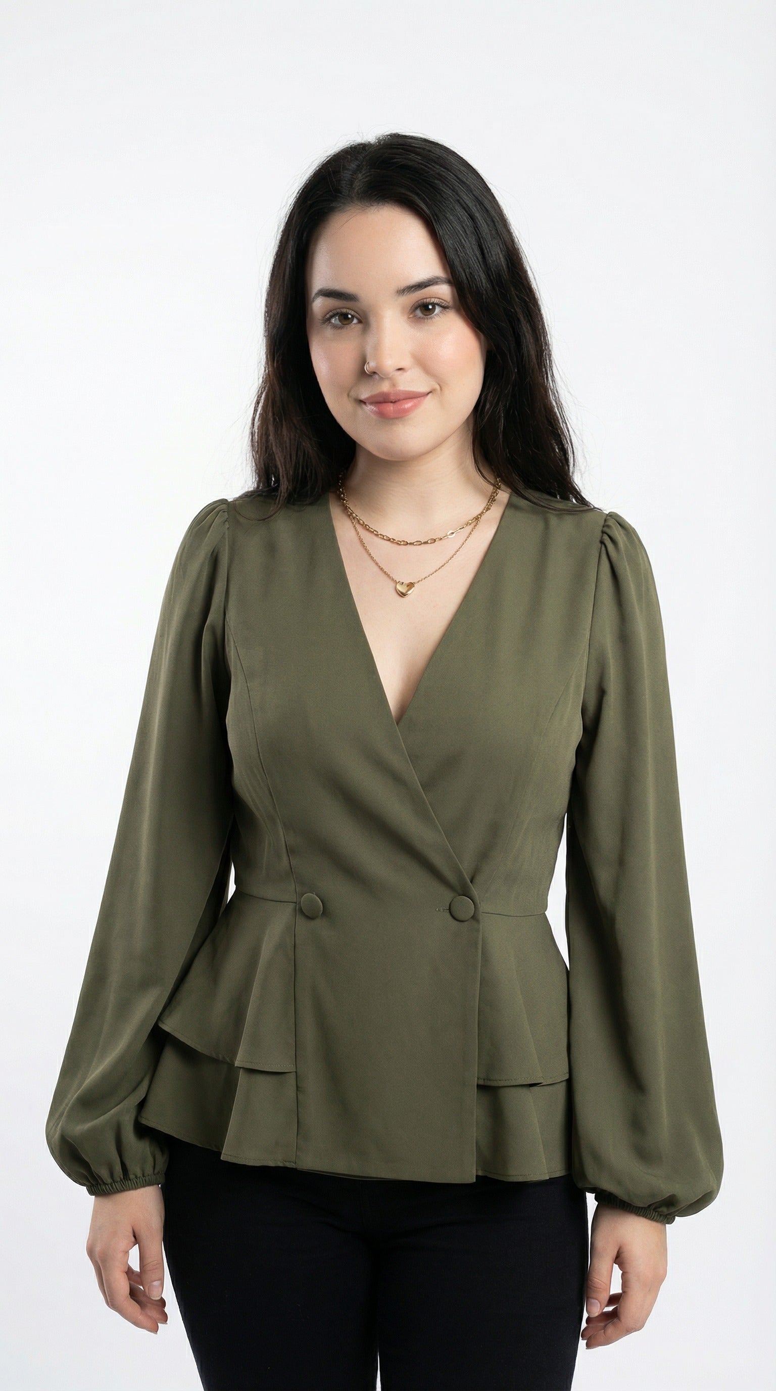 Woman wearing an olive green peplum top and blue jeans against a neutral background from Meleche or Meléche (short as (Mé))