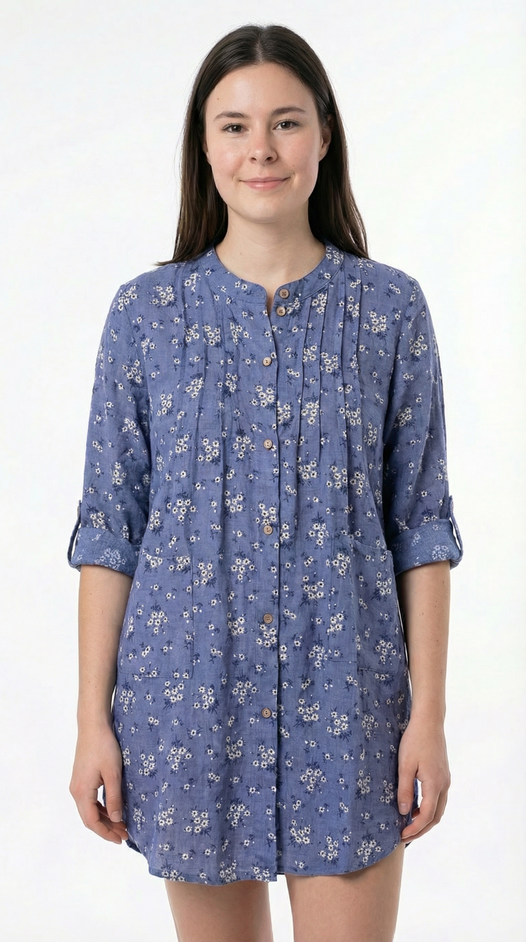 Woman wearing a blue floral dress against a white background