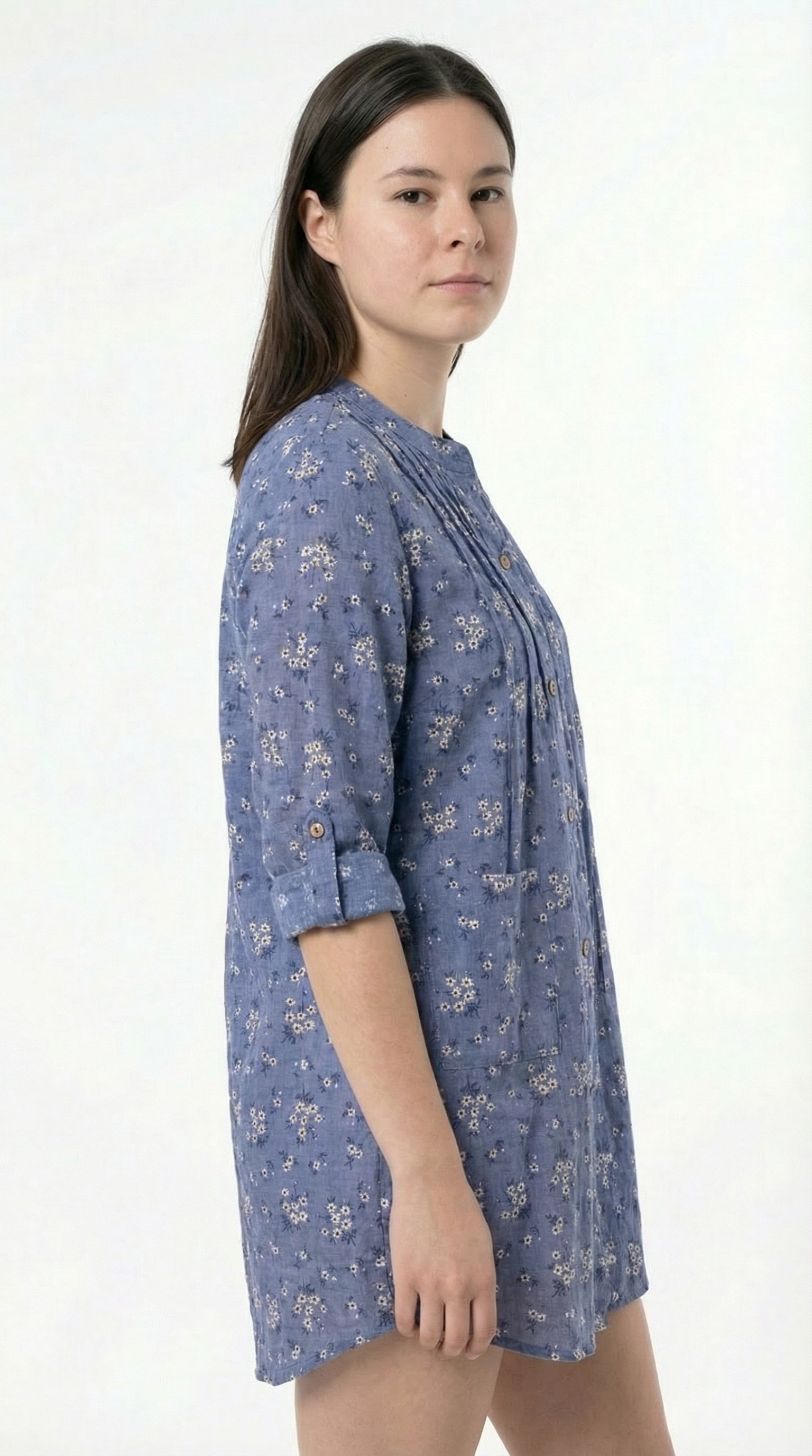 Woman wearing a blue floral dress on a white background