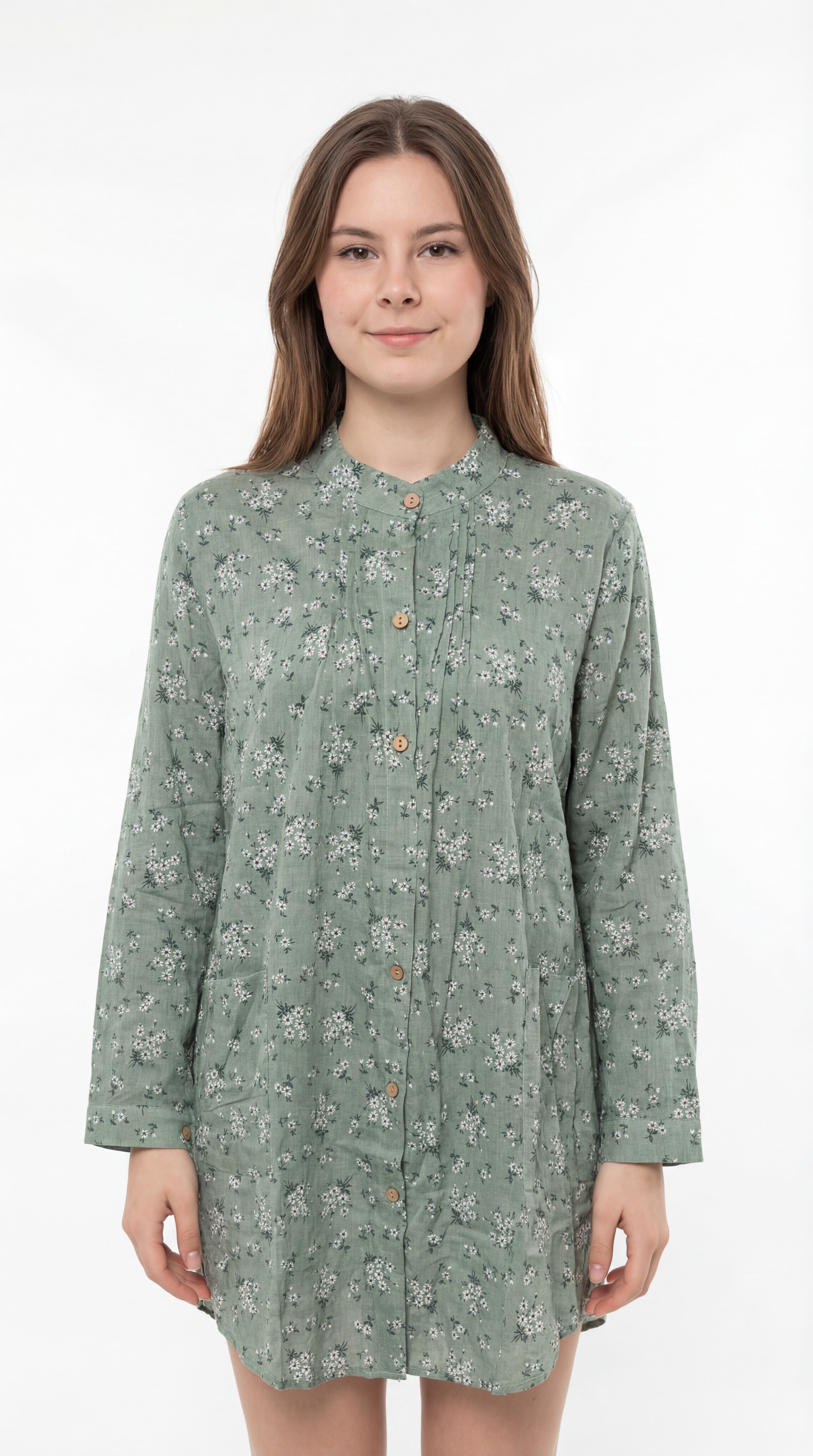 Woman wearing a green floral dress against a white background