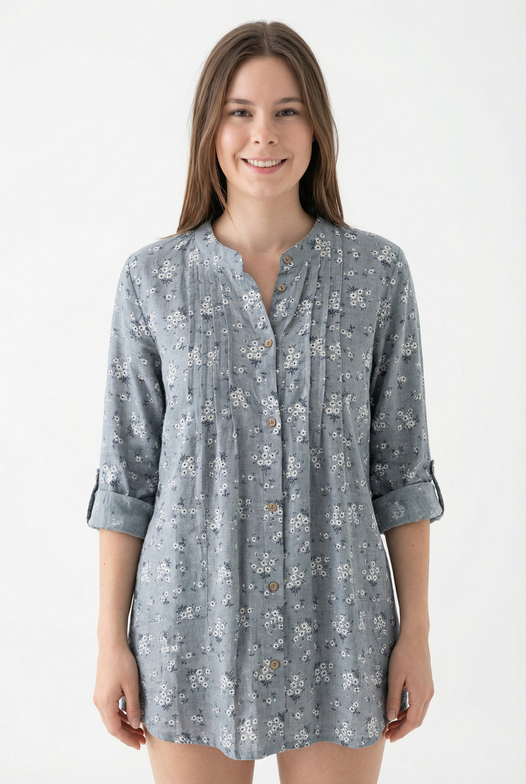Woman wearing a gray floral patterned shirt on a white from Meleche or Meléche (short as (Mé))background
