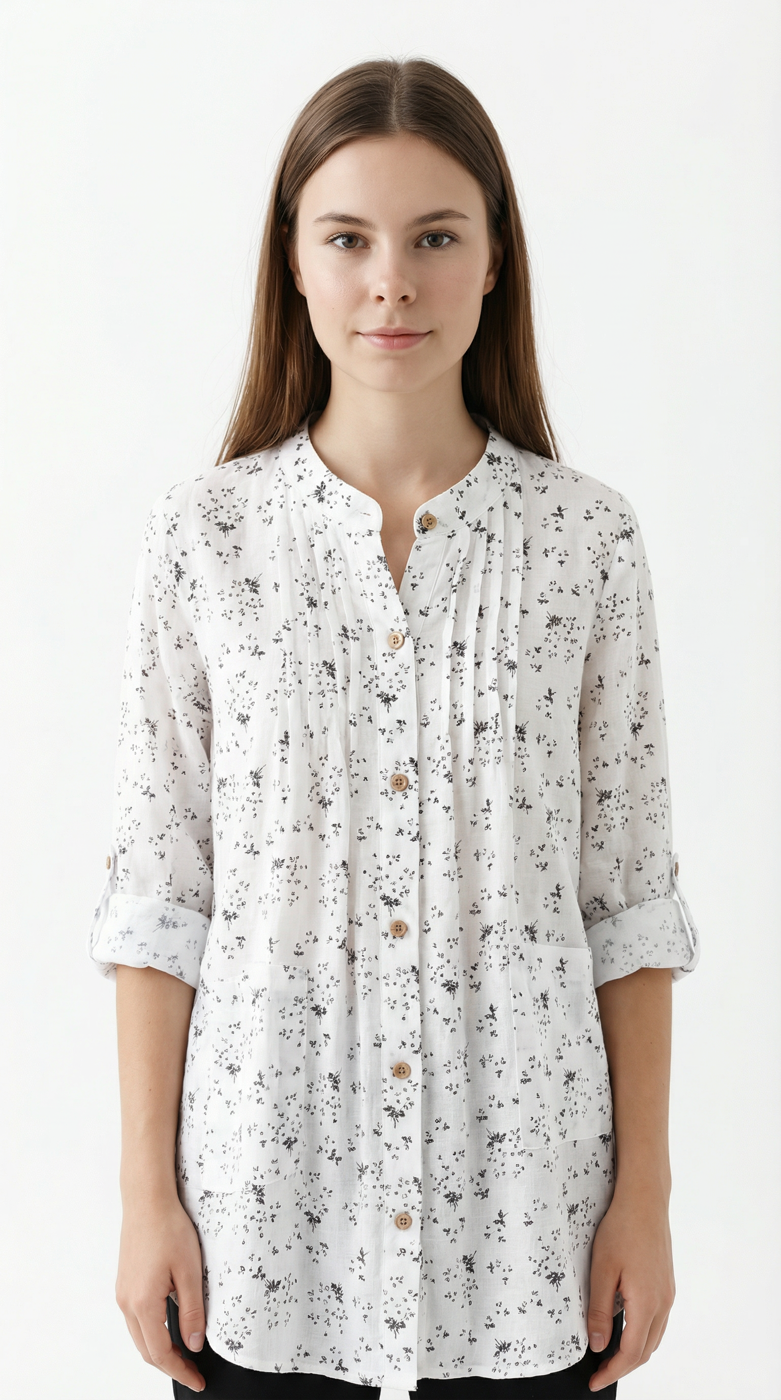 Woman wearing a white floral blouse against a white background
