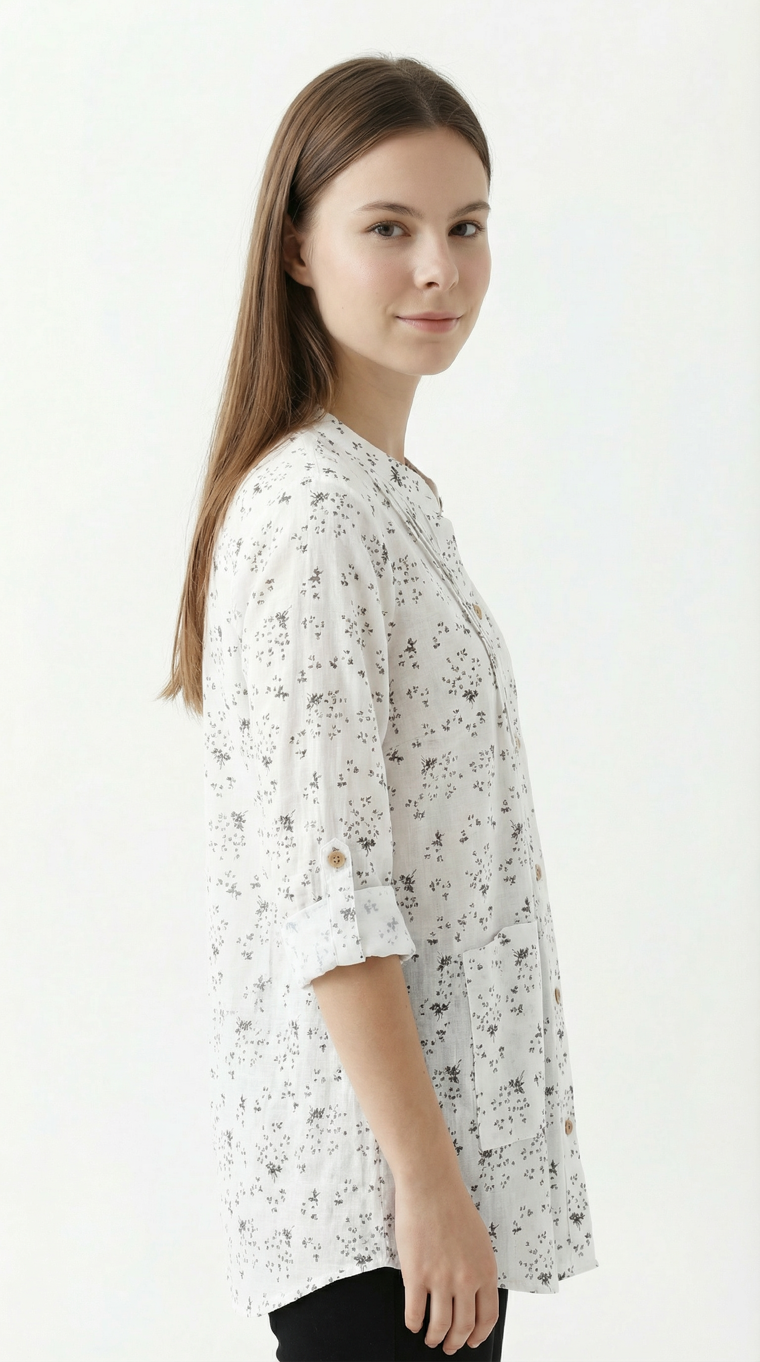 Woman wearing a white floral blouse on a white background