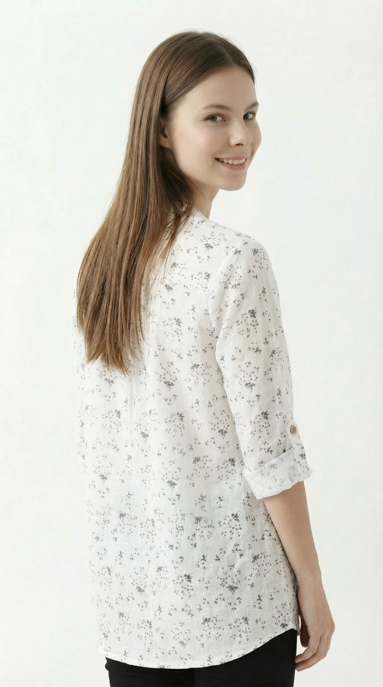 Woman wearing a white floral blouse on a white background
