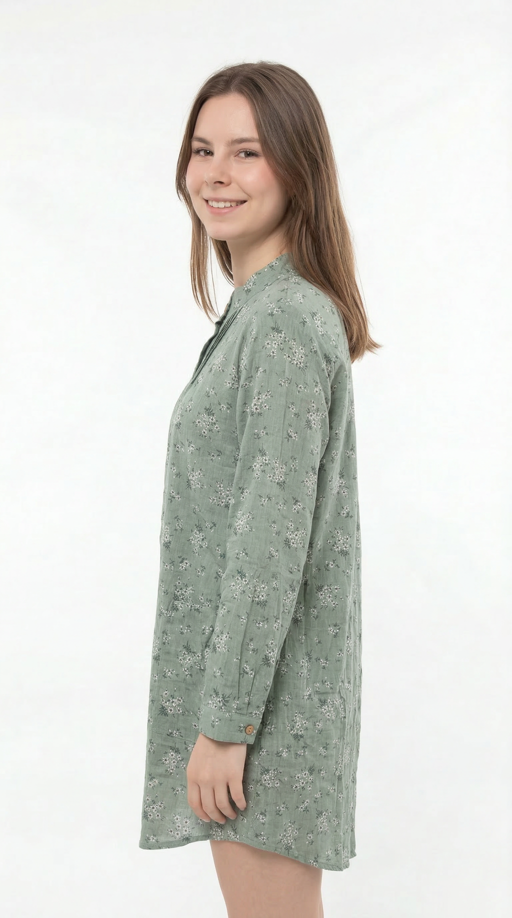 Woman wearing a green floral dress on a white background