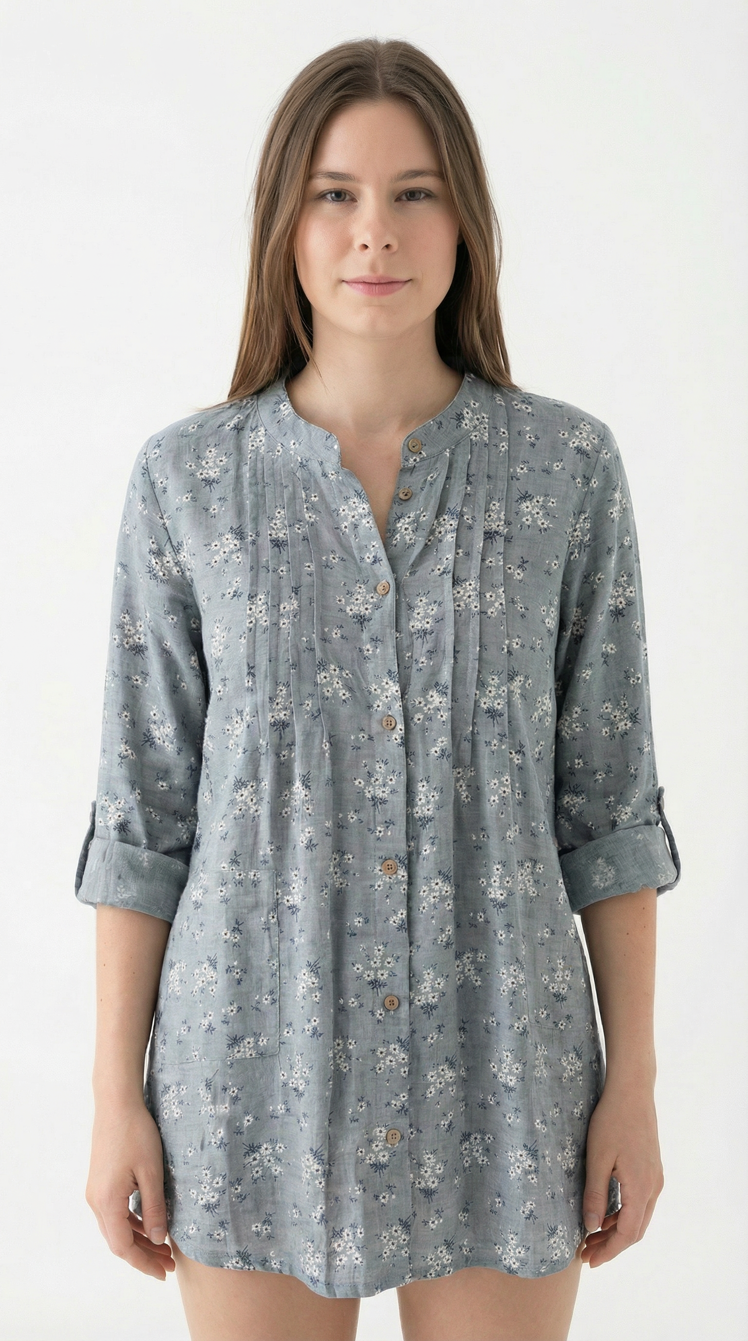 Woman wearing a gray floral patterned shirt dress on a white background