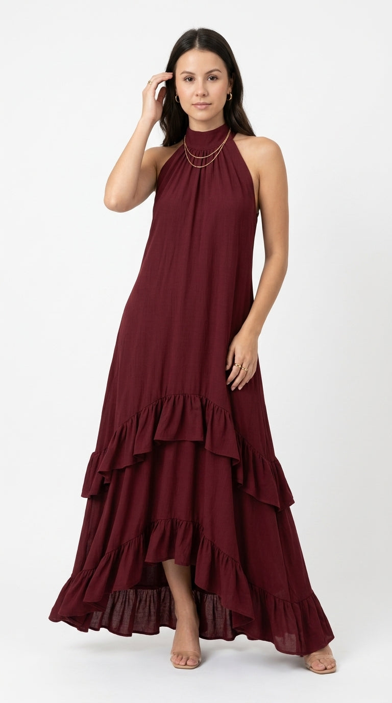 A woman modeling a sleeveless, high-neck, tiered maxi dress in deep burgundy against a plain white studio background, from Meleche Fashion USA or Meléche (short as (Mé))