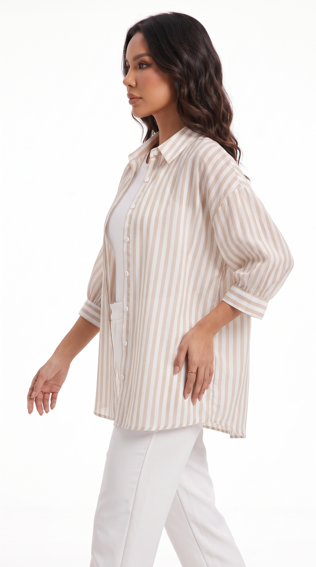 A woman modeling a cream and beige vertically striped button-up shirt with three-quarter sleeves, worn over a white top and white pants, against a plain white studio background, from Meleche Fashion USA or Meléche (short as (Mé))