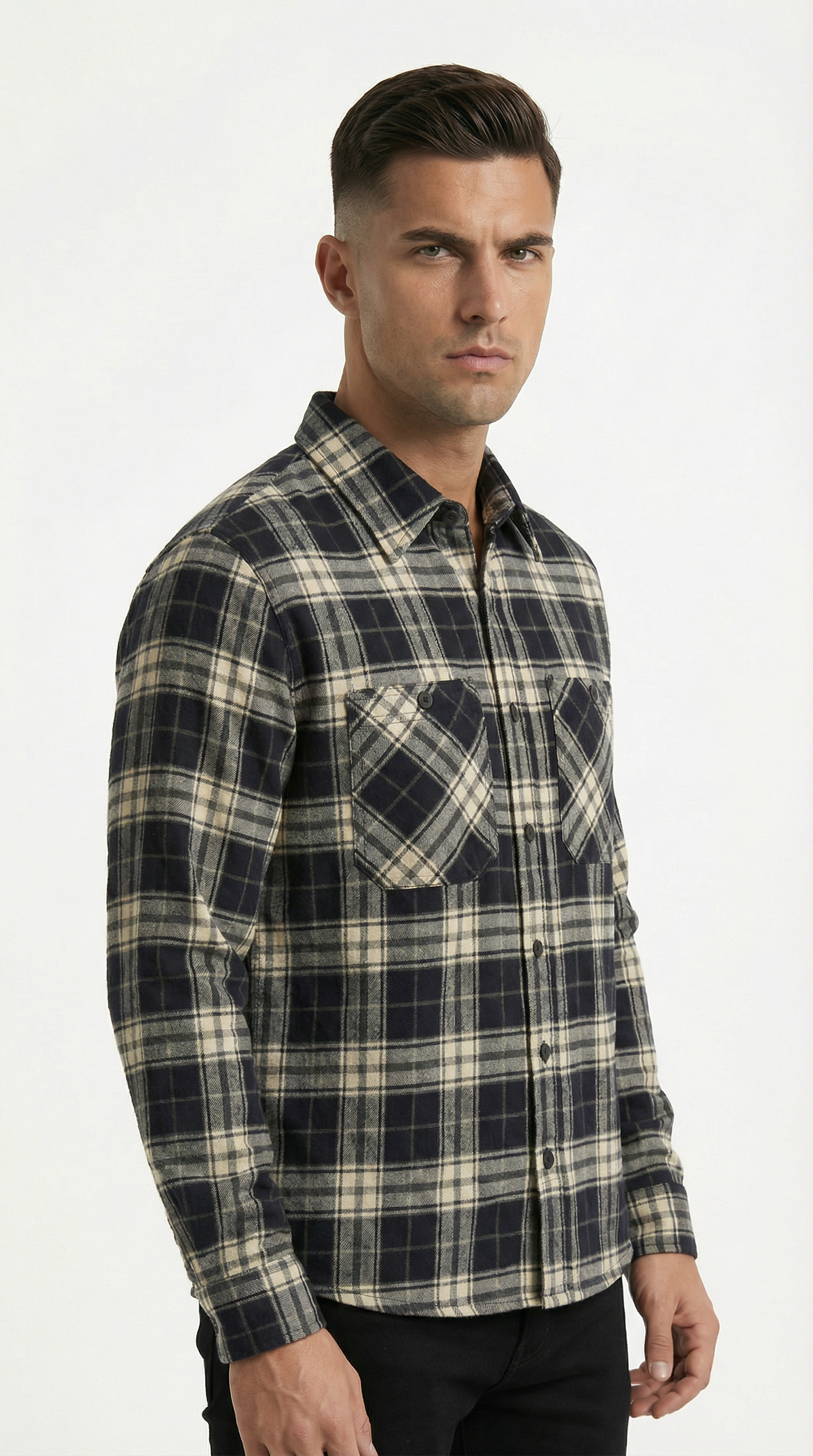 Man wearing a black and beige plaid shirt on a white background