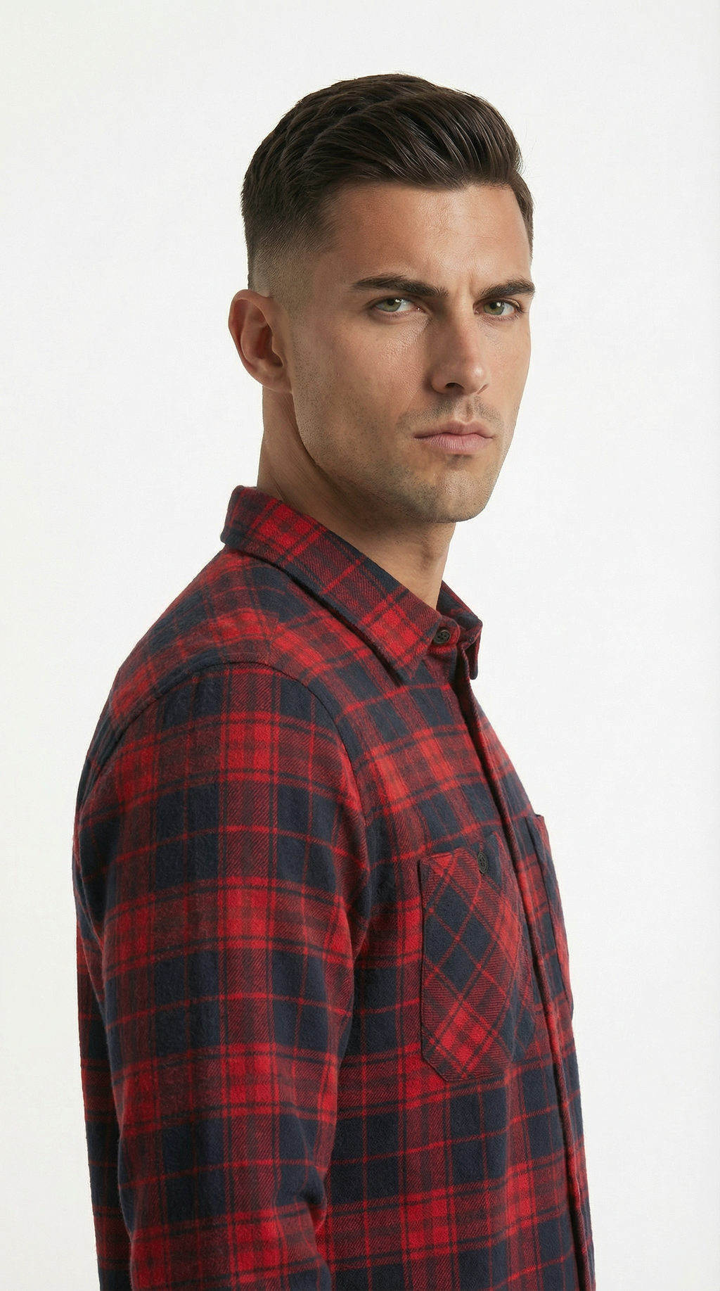 Man wearing a red and black plaid shirt against a white background