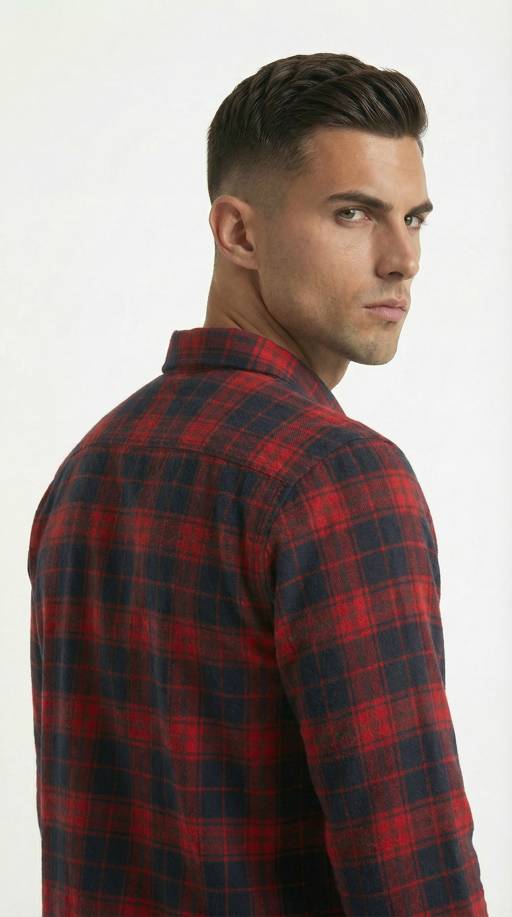 Man wearing a red and black plaid shirt on a white background
