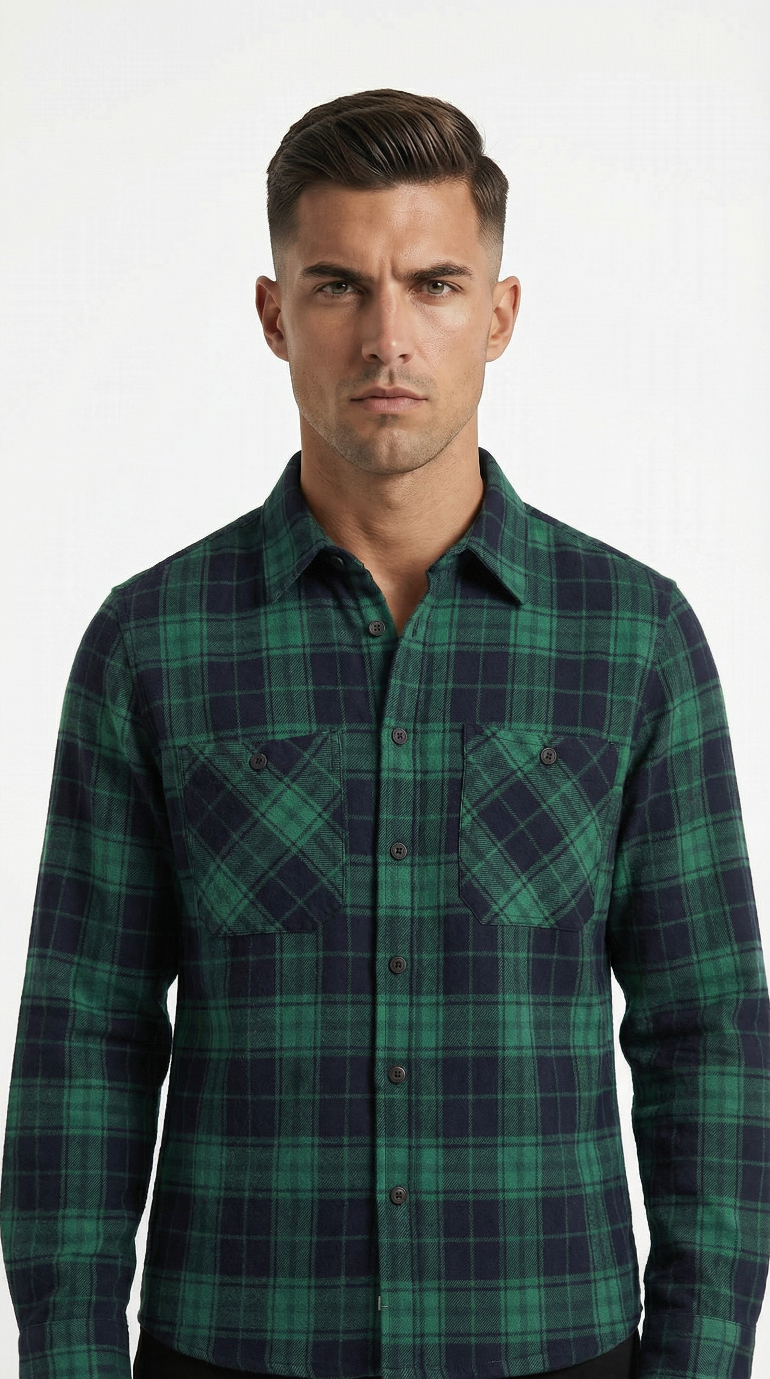 Man wearing a green and navy plaid shirt against a white background
