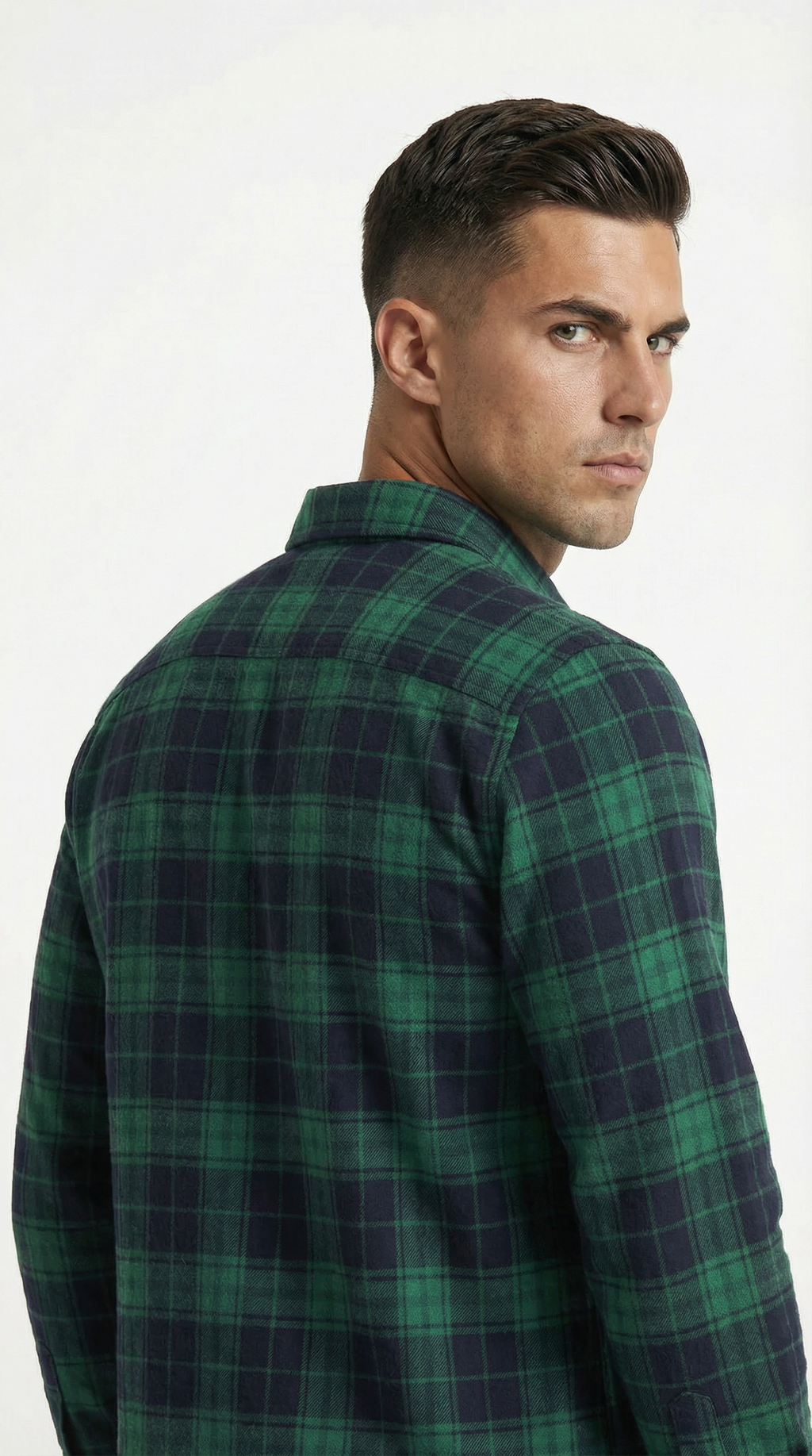 Man wearing a green and navy plaid shirt on a white background