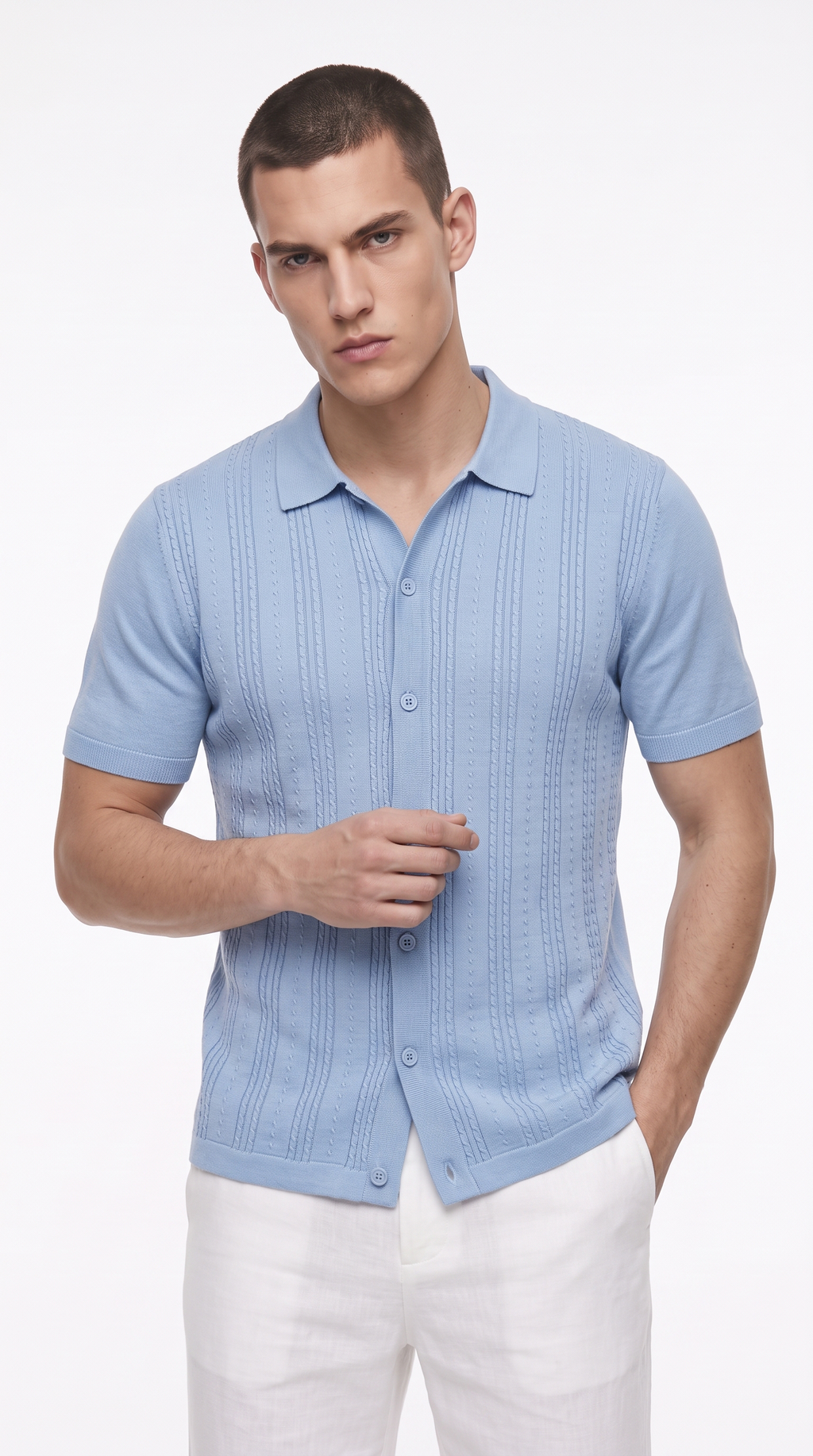 A man wearing a light blue short-sleeve knit polo shirt with a textured vertical pattern and white trousers, photographed against a clean white studio background, from Meleche Fashion USA or Meléche (short as (Mé))