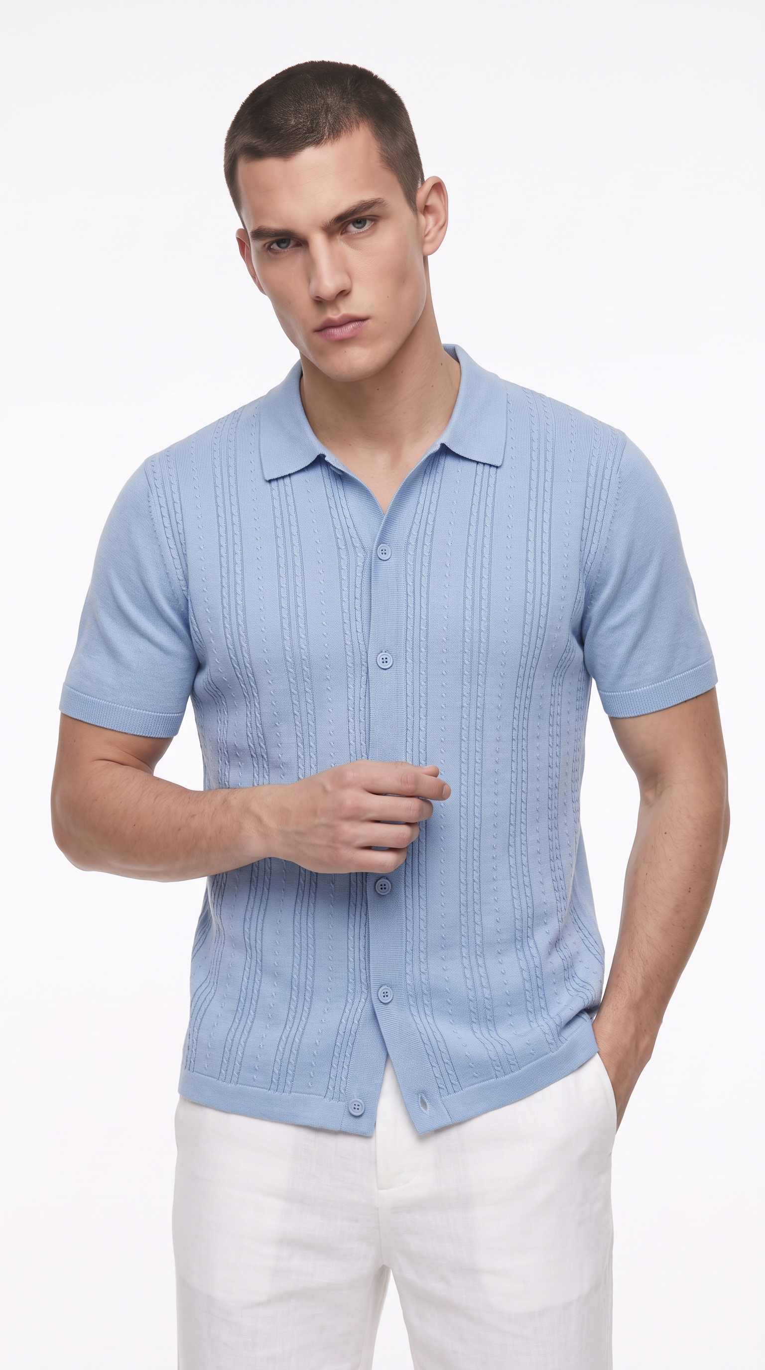 A man wearing a light blue short-sleeve knit polo shirt with a textured vertical pattern and white trousers, photographed against a clean white studio background, from Meleche Fashion USA or Meléche (short as (Mé))