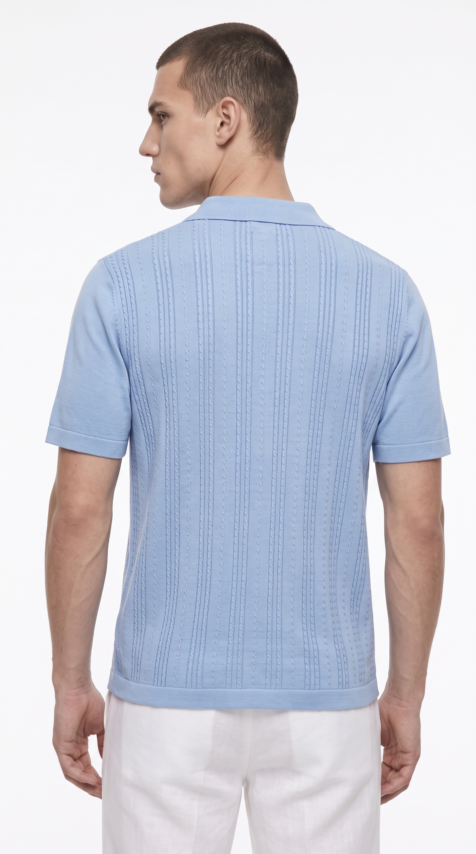 A man viewed from the back wearing a light blue short-sleeve knit polo shirt with vertical textured stripes and white trousers, against a plain white studio background, from Meleche Fashion USA or Meléche (short as (Mé))